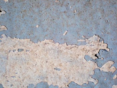 Blue surface recedes, jagged white edges emerge, gritty scars remain