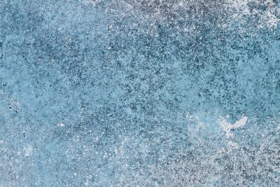 Teal paint meets the rust, orange veins bleed on the car, grit marks the finish