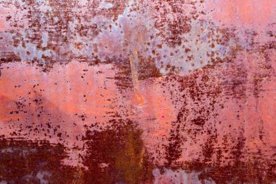 Teal skin turns to rust, dark islands on the steel, decay takes the light