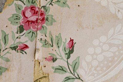 Weathered wood grain, silver and brown minerals claim the board, grit holds the age