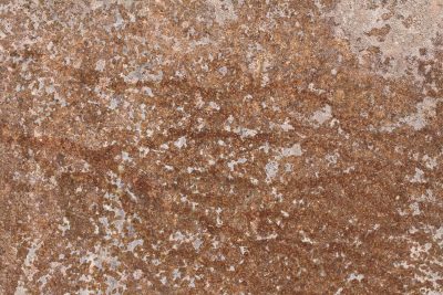 White flakes curl from the grain, grey shadows show beneath, time wears the finish