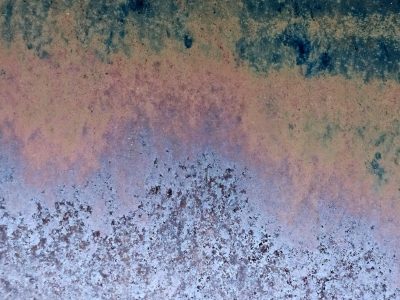 Blue grit at the base, orange stains the center line, dark waves drift above