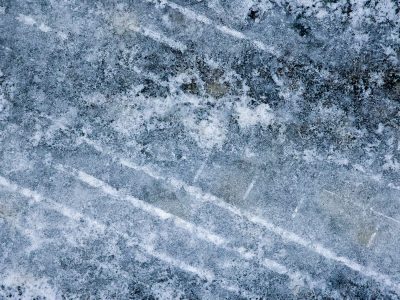 White lines scar the frost, rubber treads on winter blue, time holds every mark.