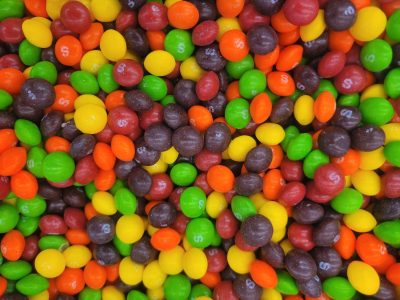 White sugar clogs the grain, yellow depths show beneath, grit marks the organic clump