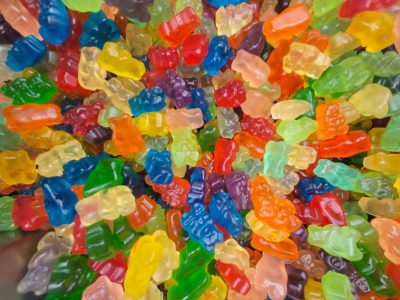 Tiny bears collide, translucent colors sparkle, sweet sugary pile