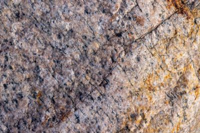 White vein cuts the blue field, jagged mineral traces the skin, light catches the edge