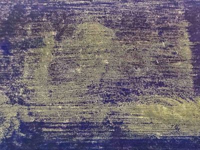 Yellow spray on the shed, blue mist meets the grey metal, grit holds the pattern