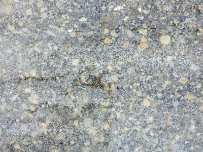 Yellow stones emerge, grey dust holds the broken grit, earth wears down the path