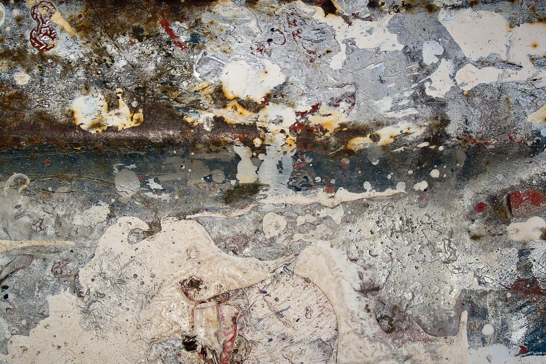 White paint splashes out, silver metal shows beneath, rust blooms in the dark