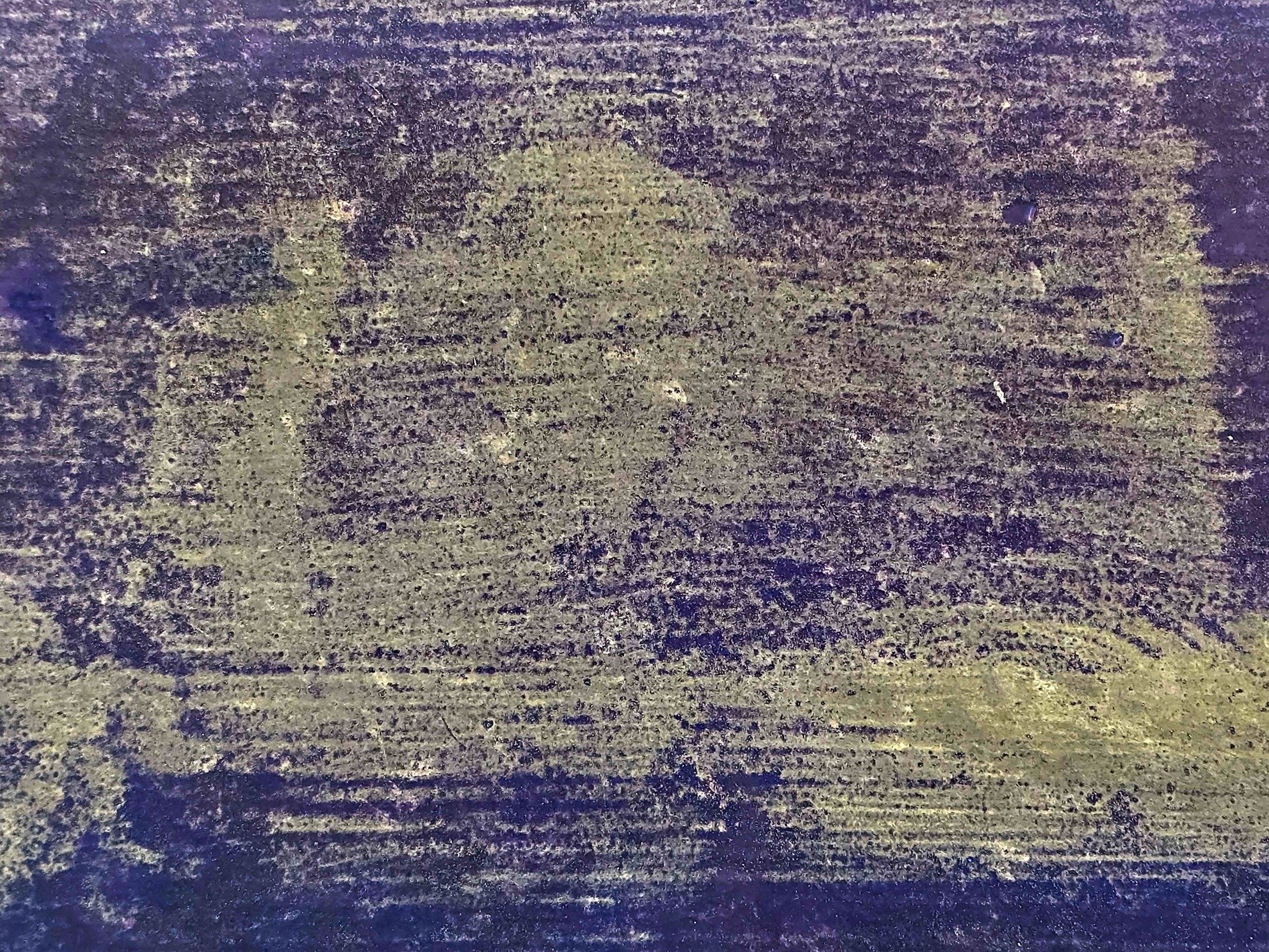 Yellow spray on the shed, blue mist meets the grey metal, grit holds the pattern