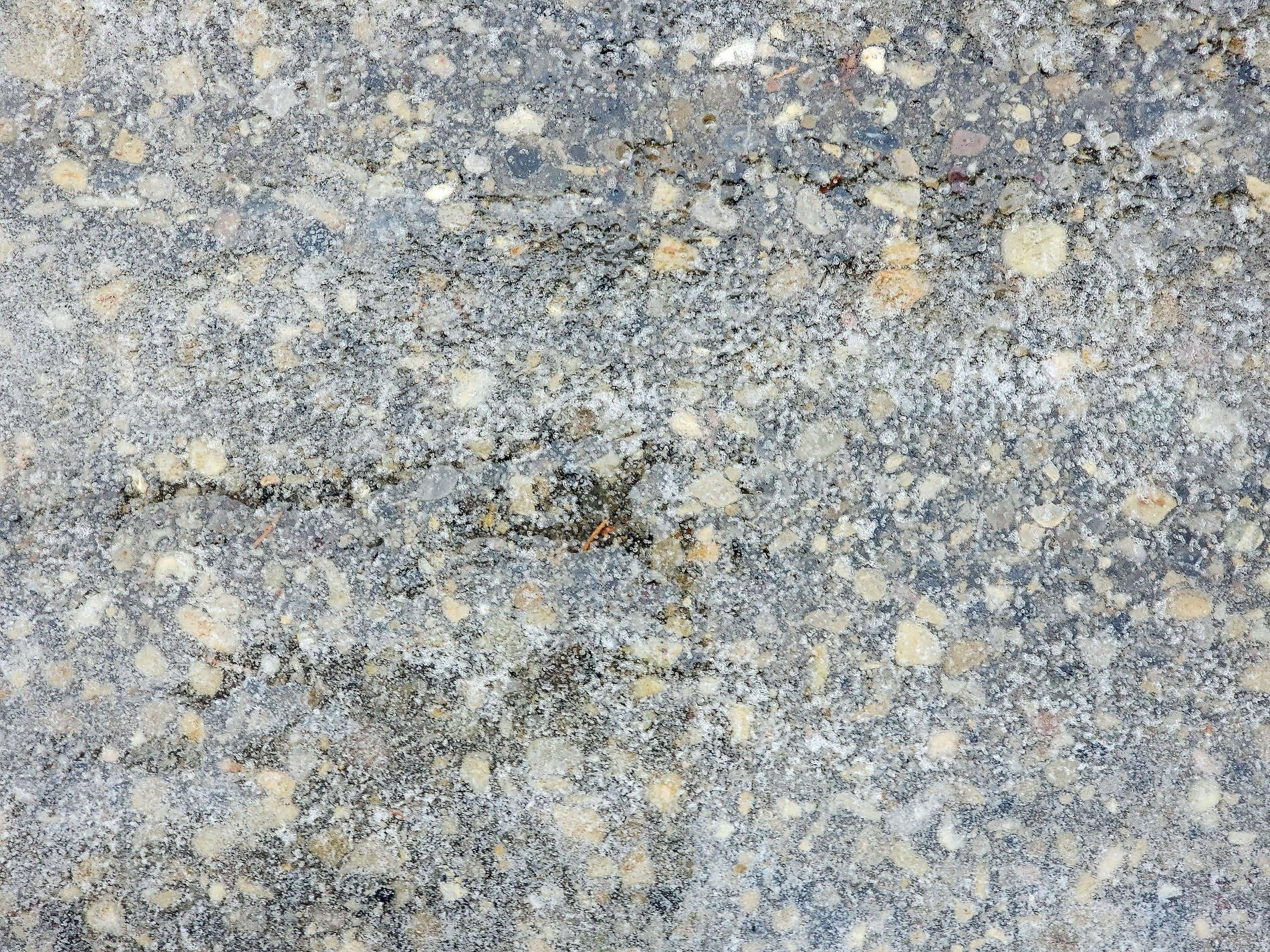 Yellow stones emerge, grey dust holds the broken grit, earth wears down the path