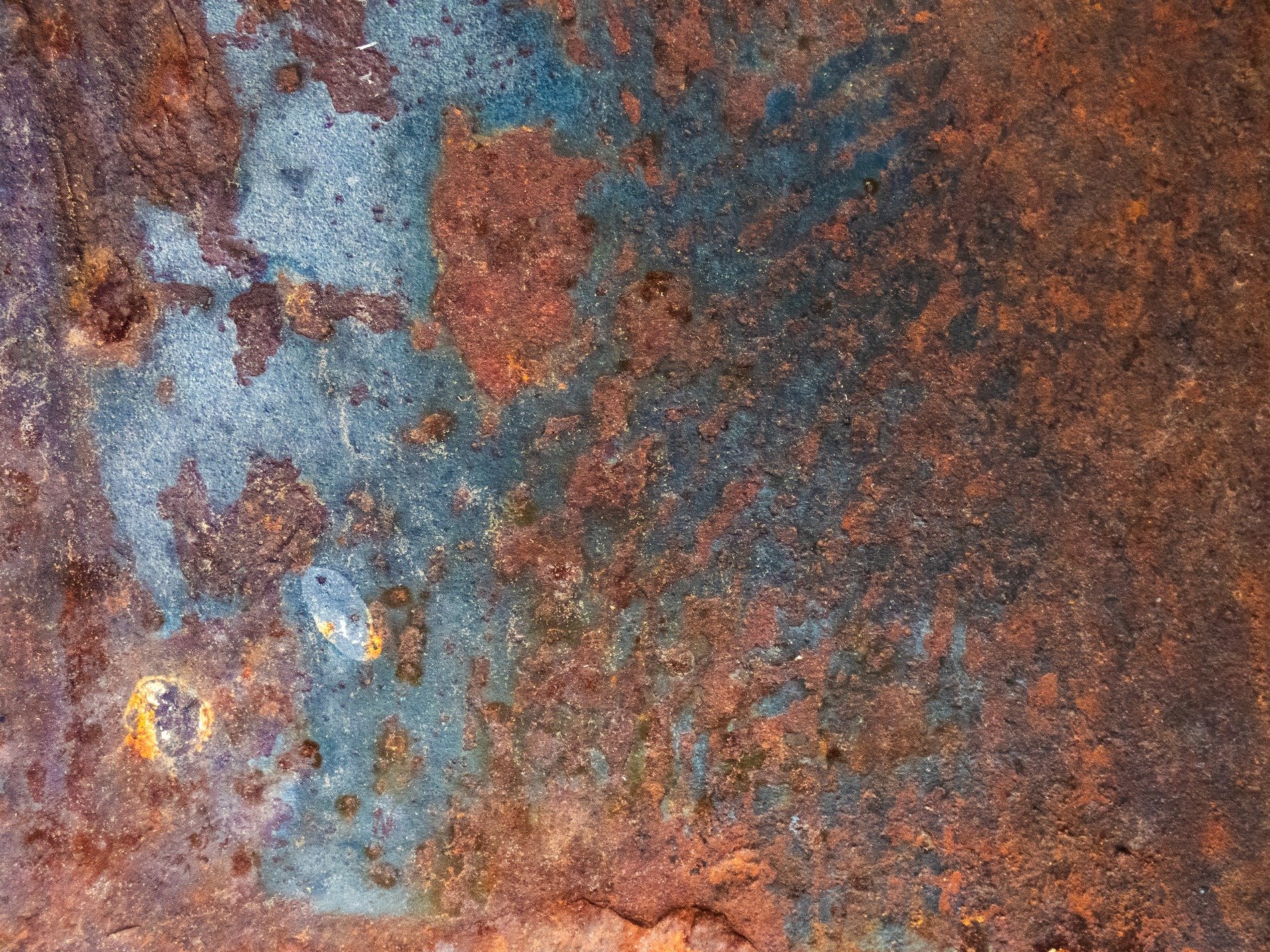Blue fields meet the rust, orange grit claims the metal, years leave a deep trace