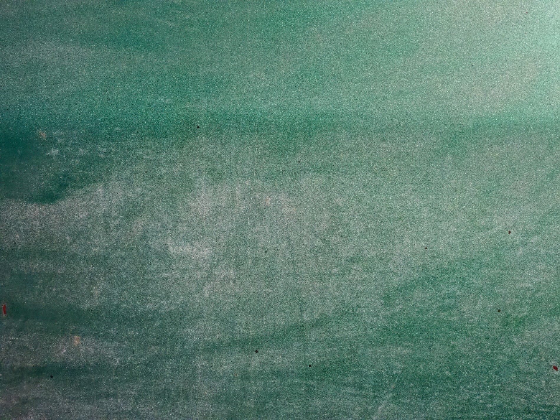 Green paint starts to fade, scratches mark the metal skin, time wears down the hull