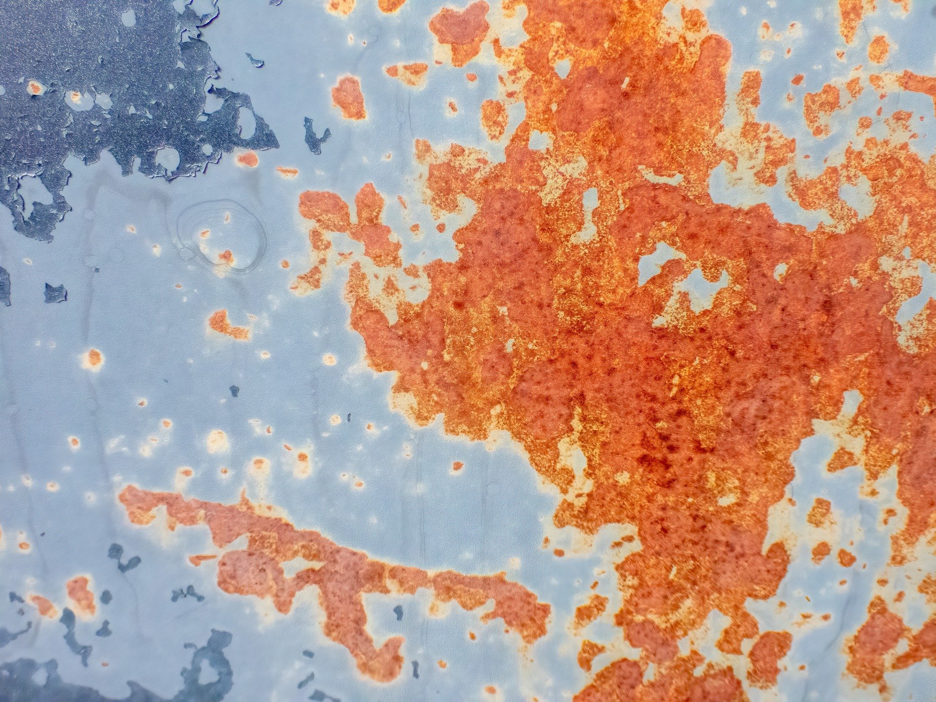 Blue paint flakes and falls, orange rust consumes the light, metal wears with age