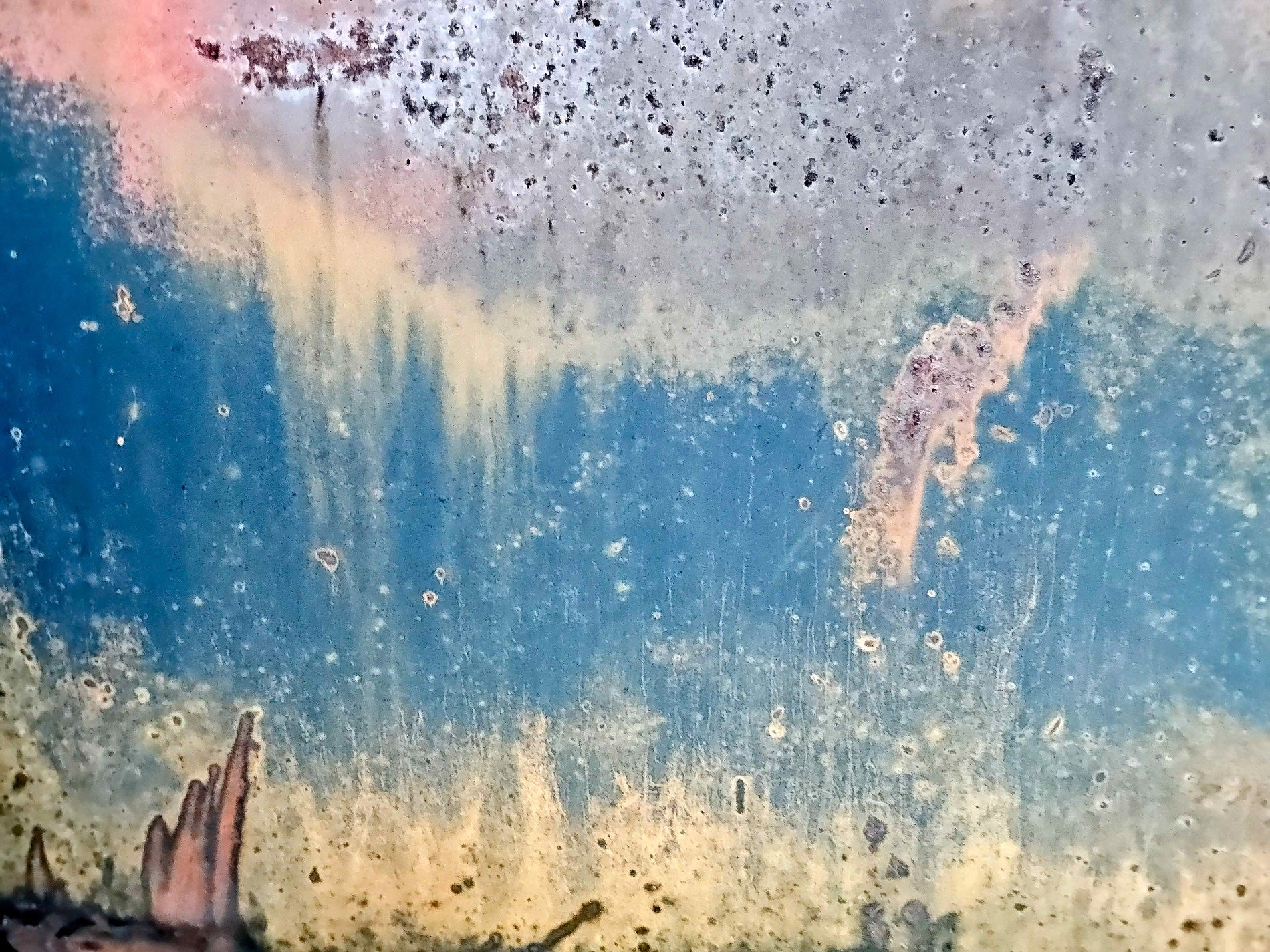 Blue paint fades away, rust blooms on the golden field, time marks the metal