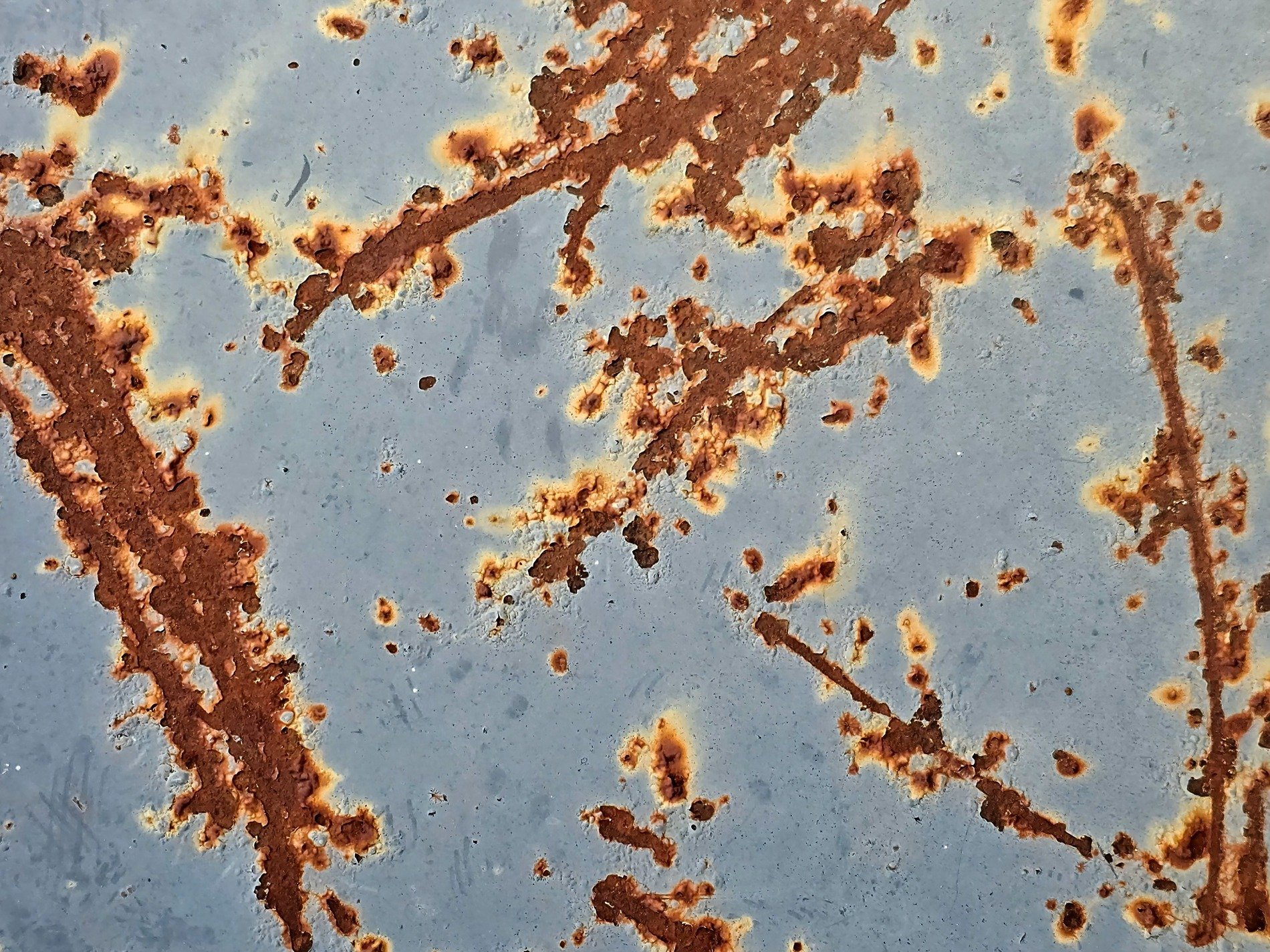 Blue paint peels away, orange rust maps out the age, metal turns to dust