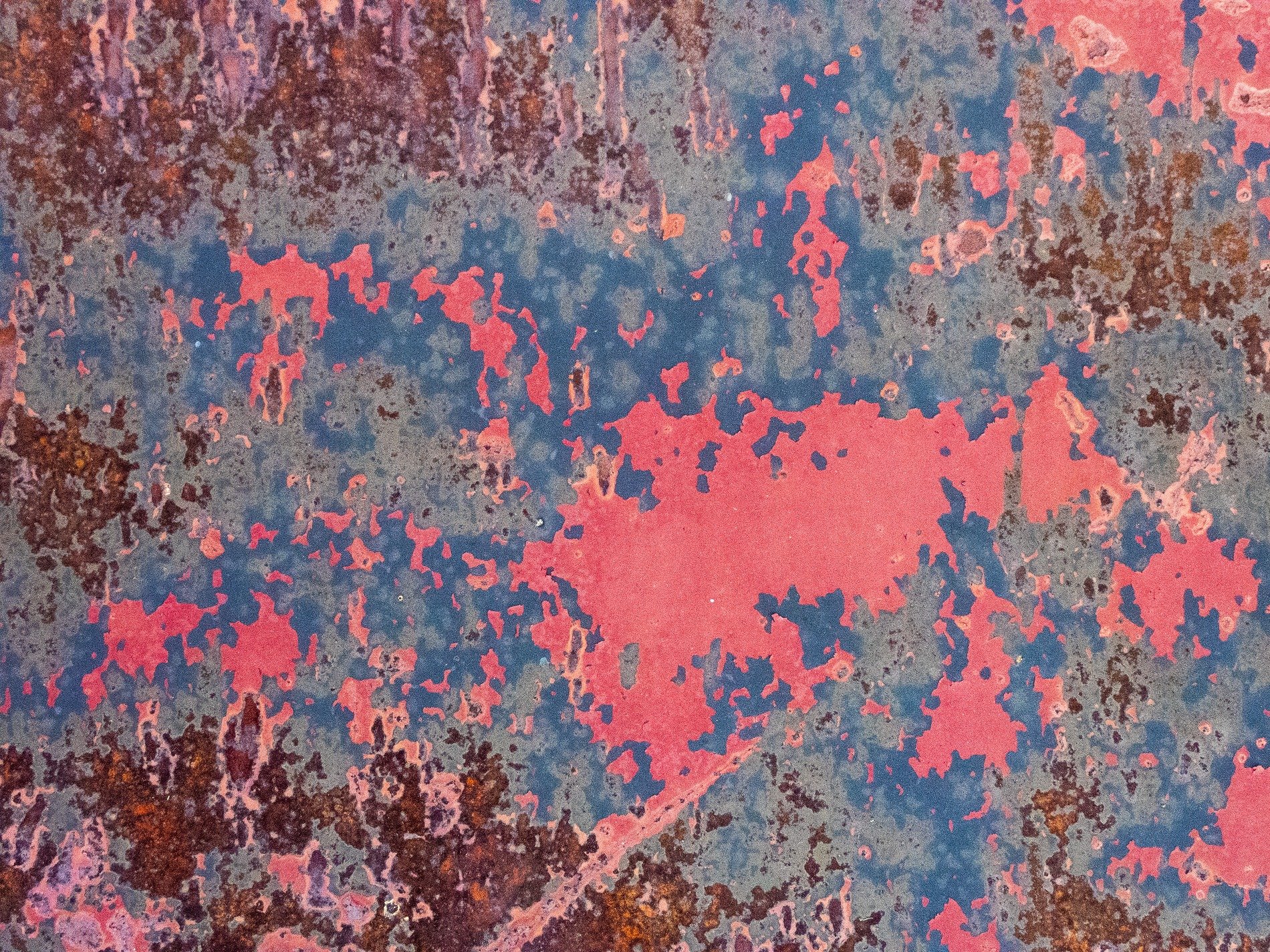 Blue skin has dark drips, vertical lines trace the field, grit marks the finish