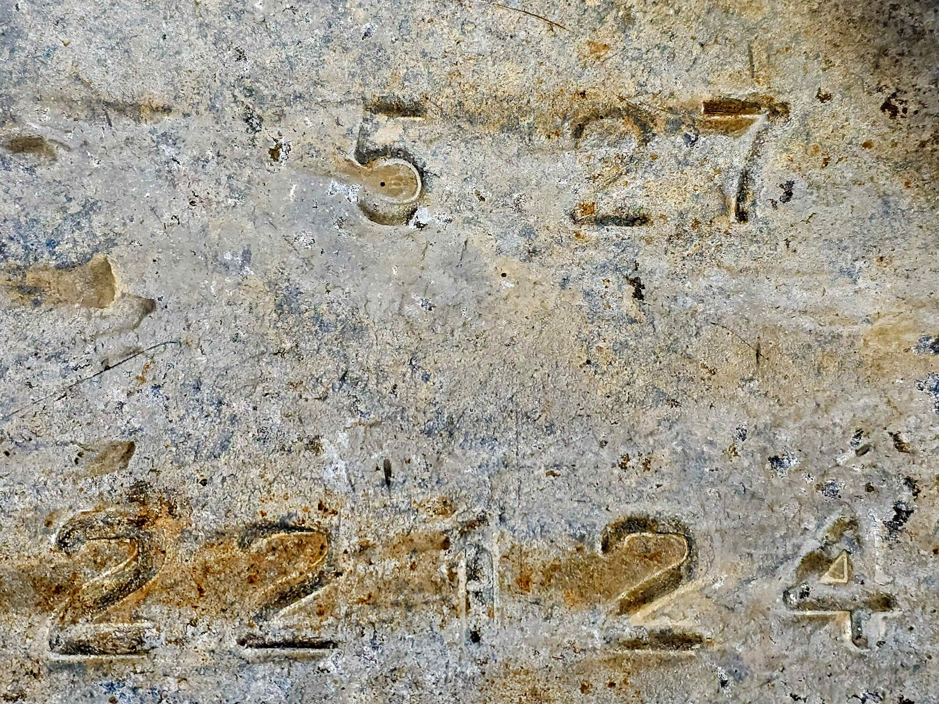 Blue skin has deep gouges, jagged lines divide the field, grit marks the finish