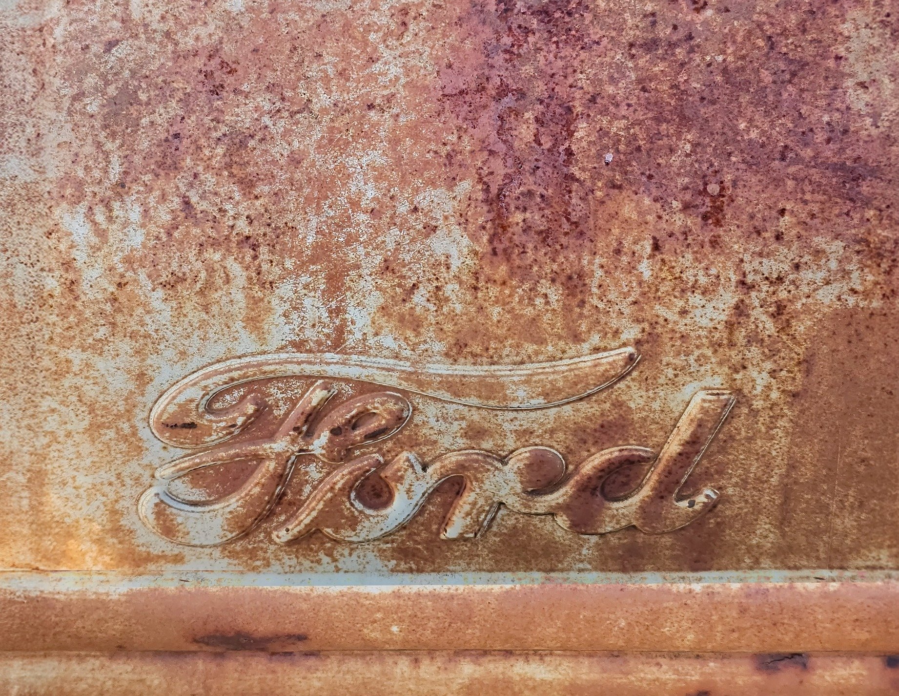 Blue skin has light marks, jagged scars trace the field, grit marks the finish