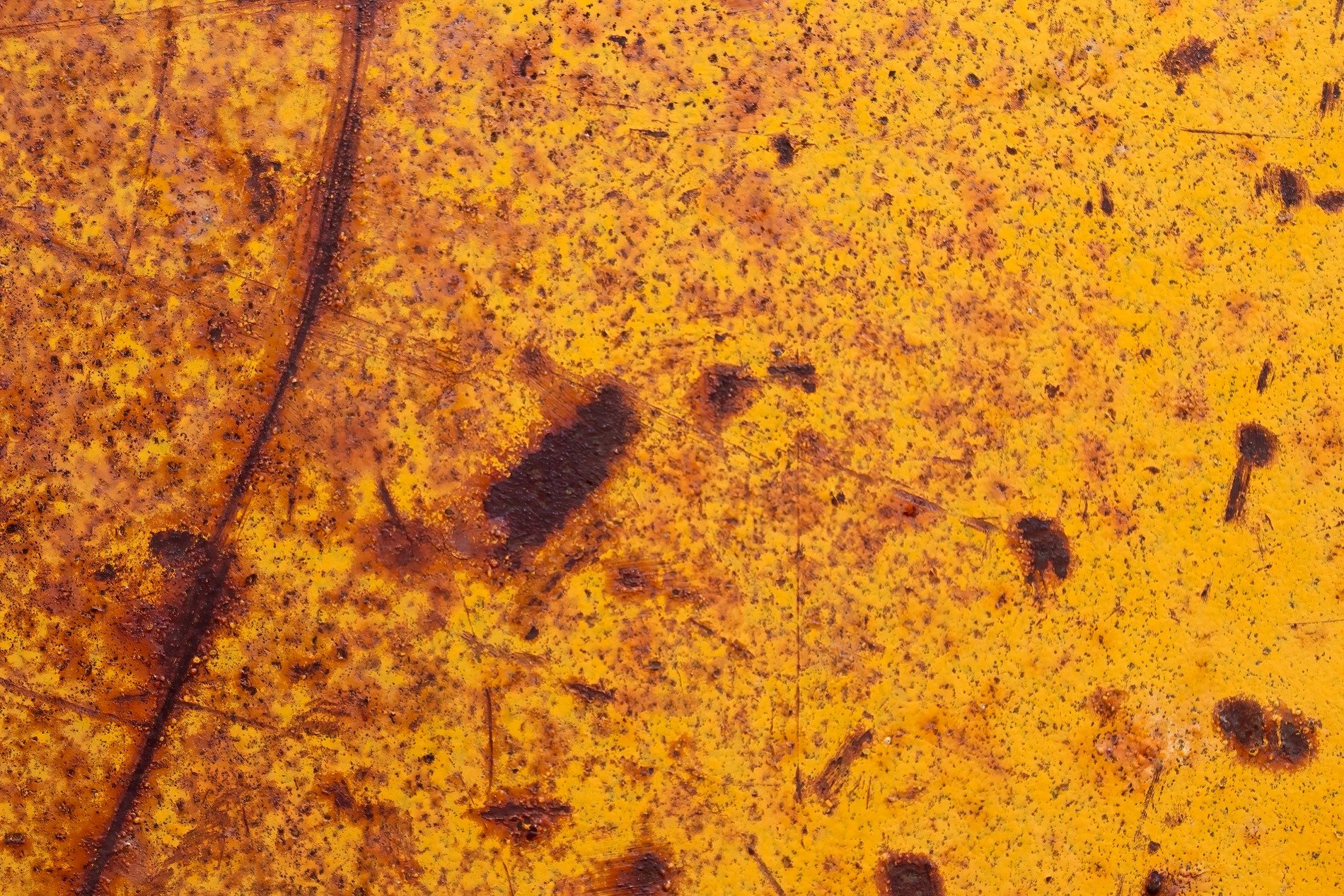 Blue skin has light marks, orange pits trace the field, grit marks the finish