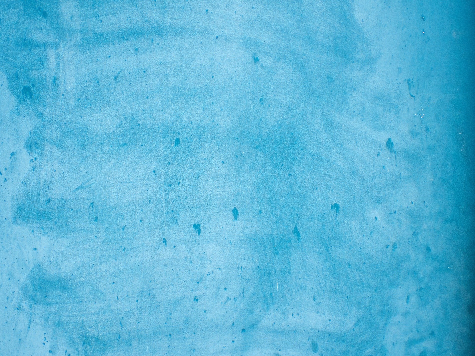 Blue skin meets the light, pale streaks trace the level field, grit marks the finish