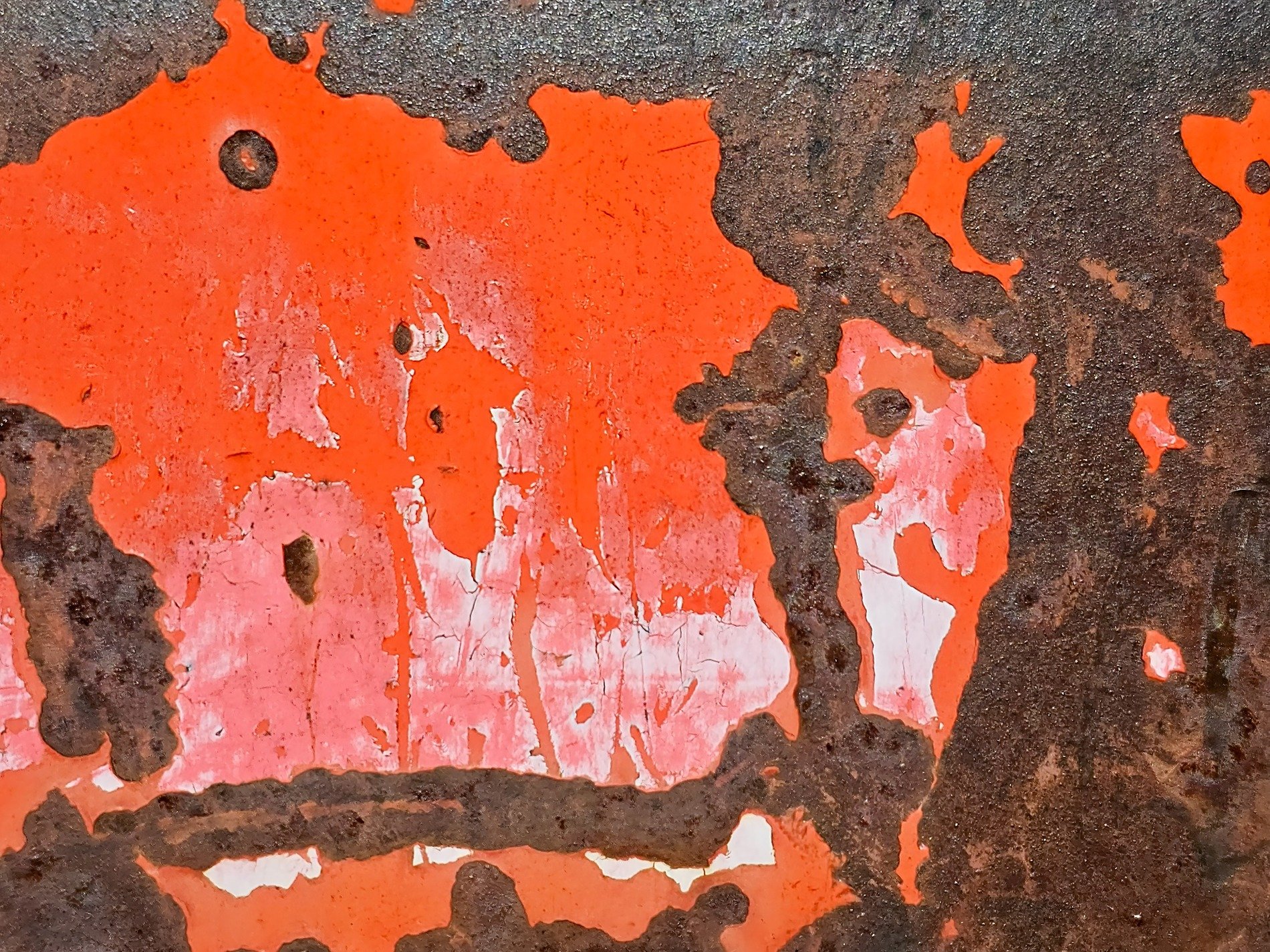 Bright orange flakes off, dark iron reveals its rust, time erodes the coat