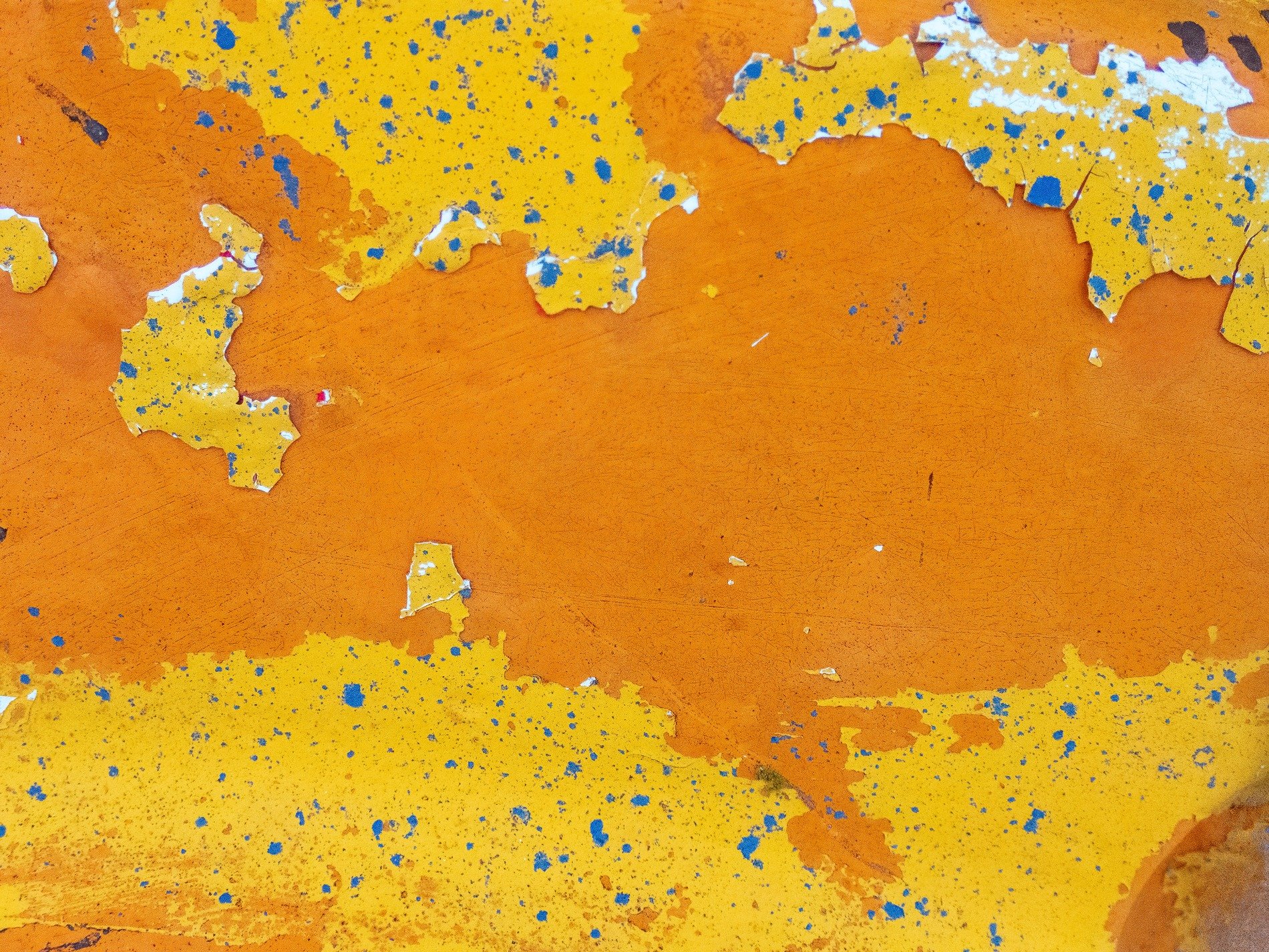 Bright yellow peels back, orange fields stretch far and wide, blue specks dot the heat