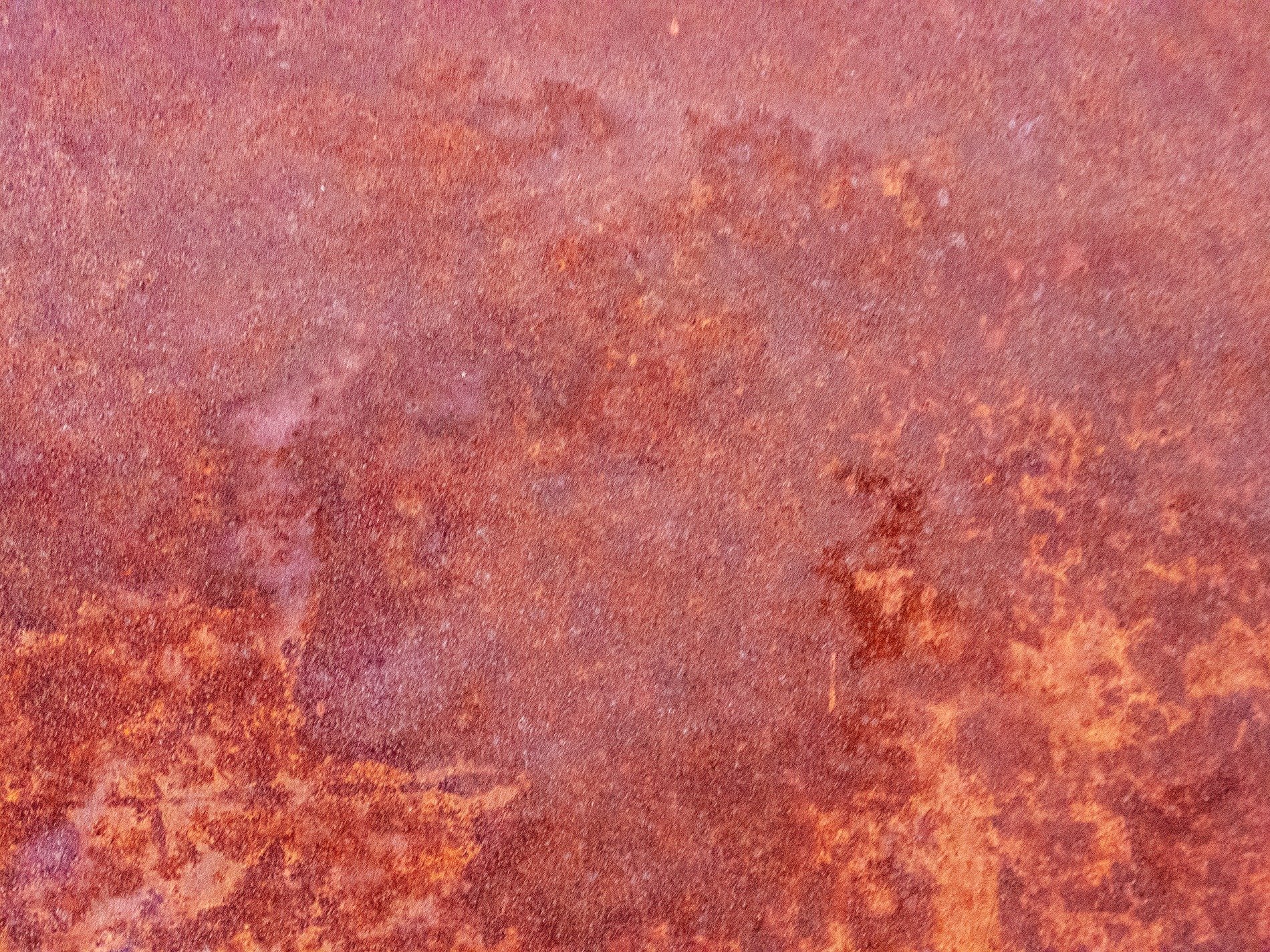 Red oxide blooms wide, iron skin starts to decay, time stains the surface