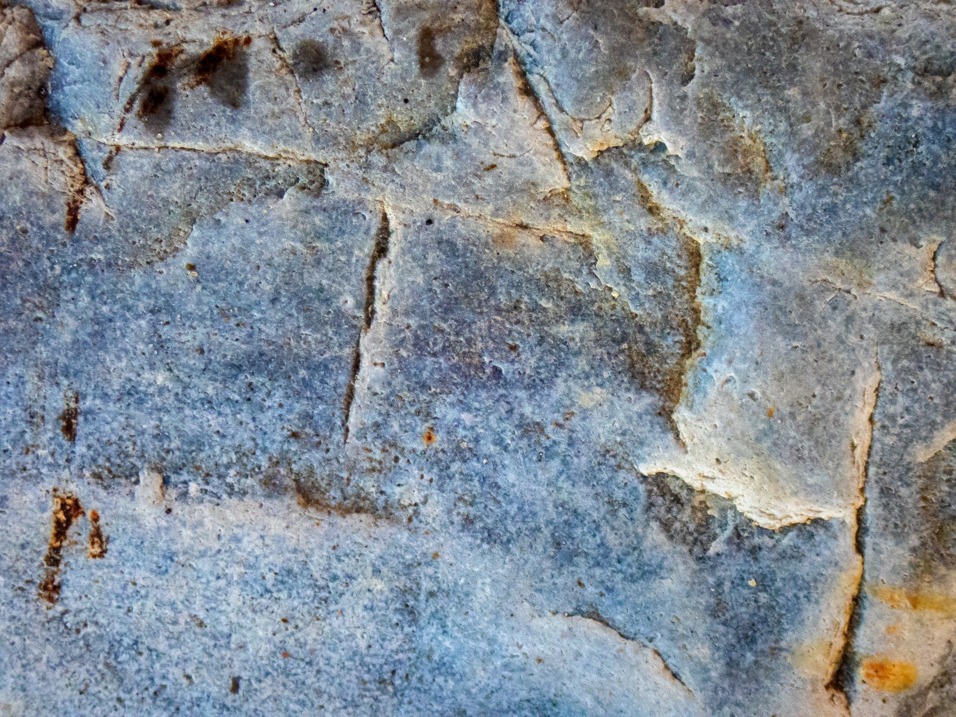 Cool blue stone is aged, iron veins creep through the cracks, earth reveals its depth