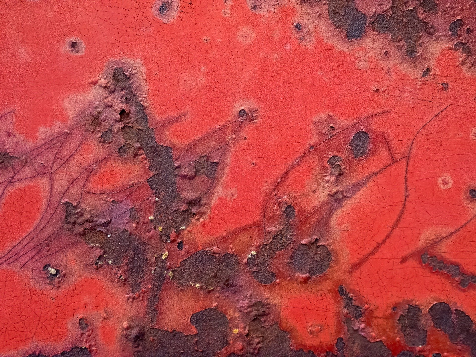 Crimson paint cracks deep, iron blooms in shades of brown, metal shows its age