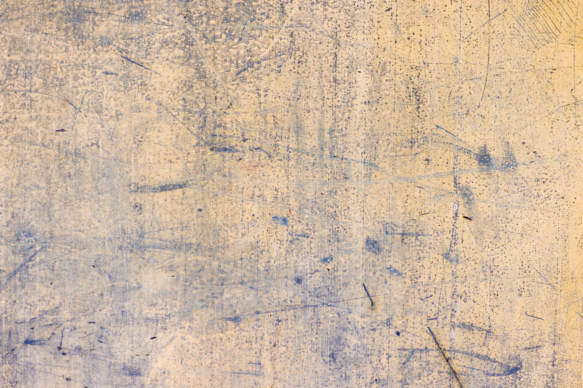 Pale gold paint fades out, indigo scratches remain, worn skin of the wall