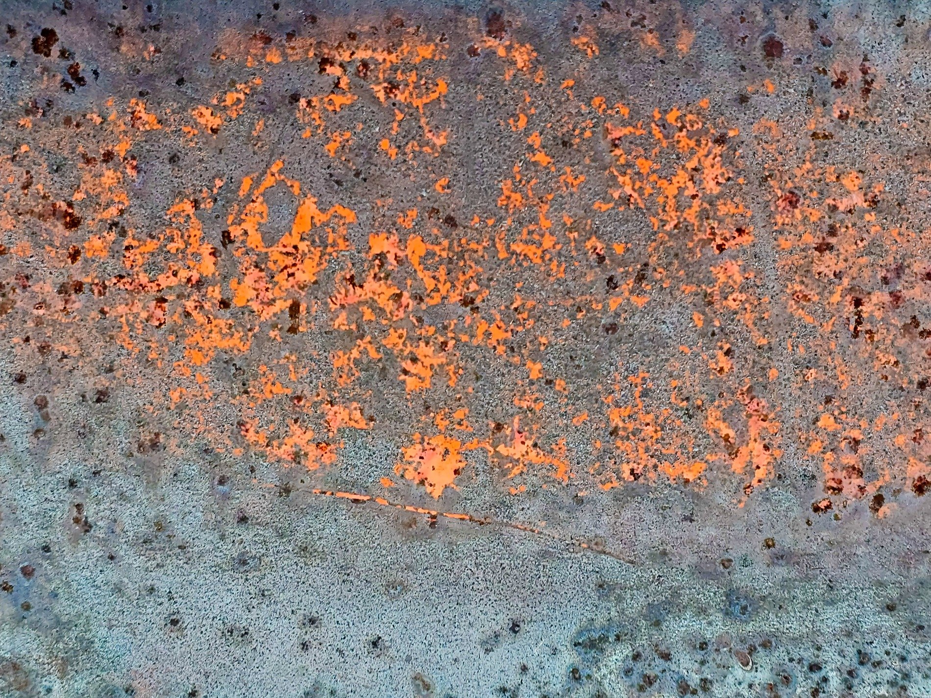Orange paint decays, rusted iron shows its age, time strips back the skin