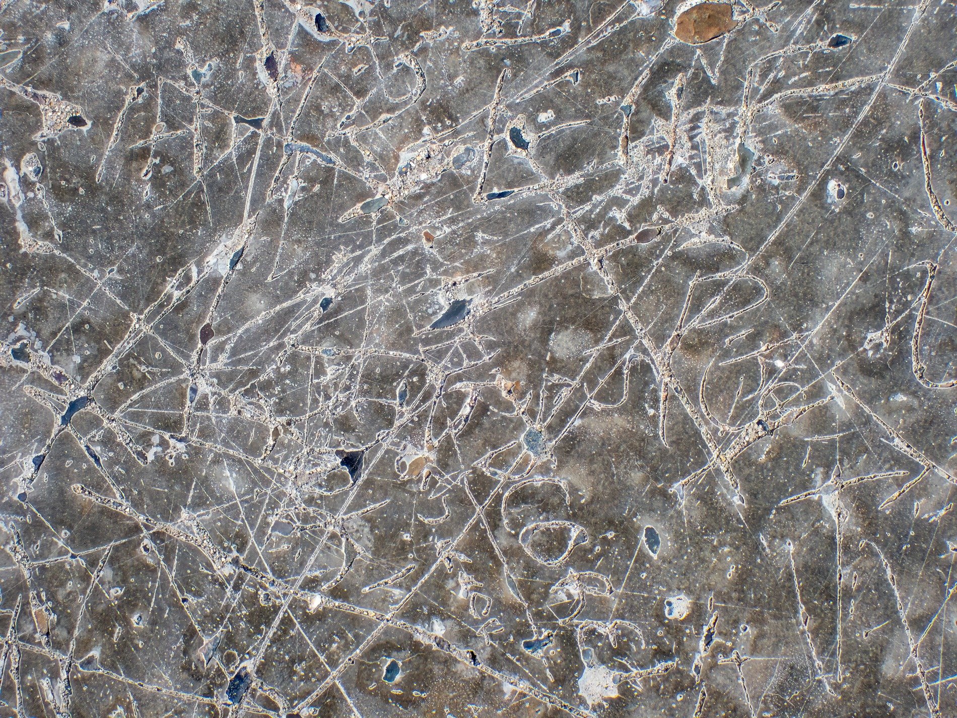 Deep lines mar the stone, etched letters fade with the years, history carved in rock