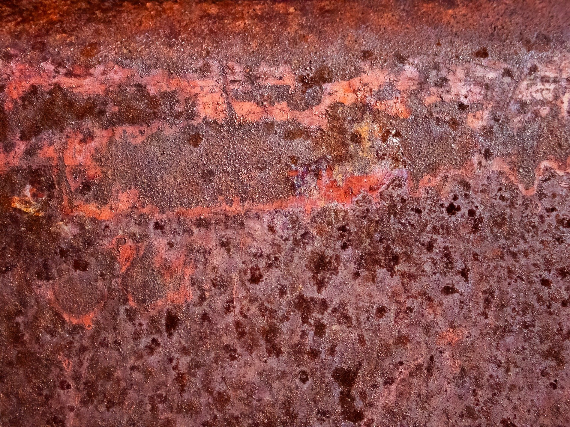 Deep pits hold the light, orange grit claims the heavy, time marks the stone