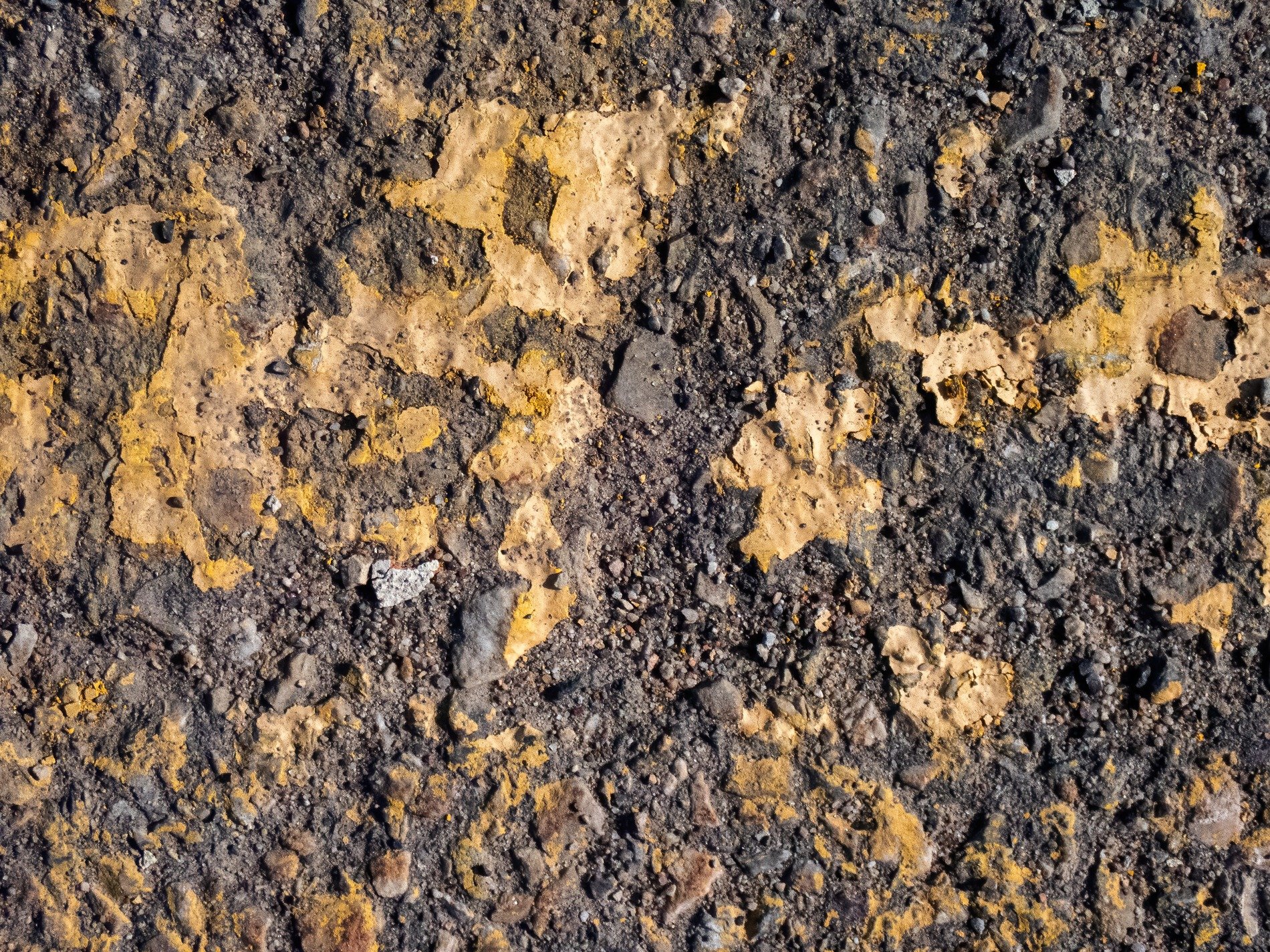 Golden paint flakes, rough grey stones hide beneath, time wears down the line