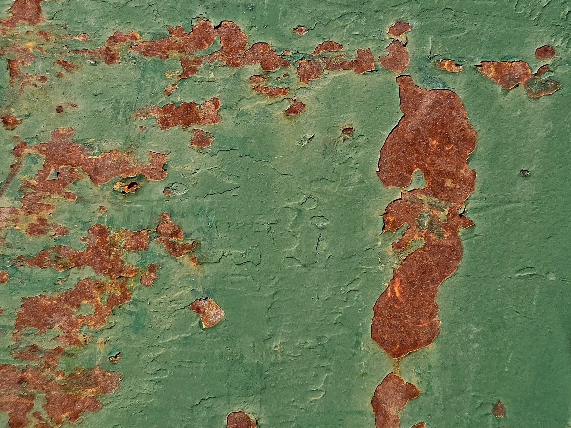 Green fields meet the rust, orange spots claim the heavy, time marks the metal