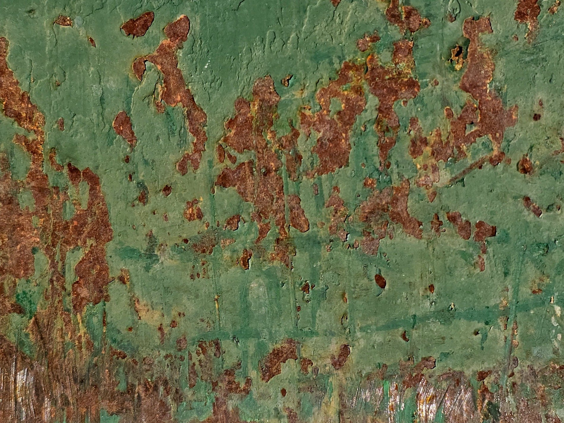 Green layers flake off, orange grit claims the field, old marks leave a trace