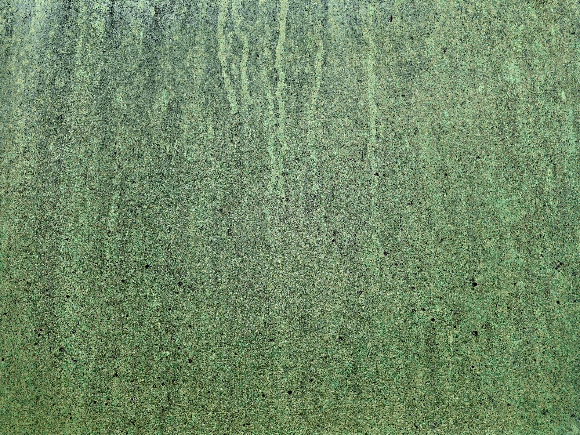Green mist has dark trails, vertical streaks trace the field, grit claims the metal