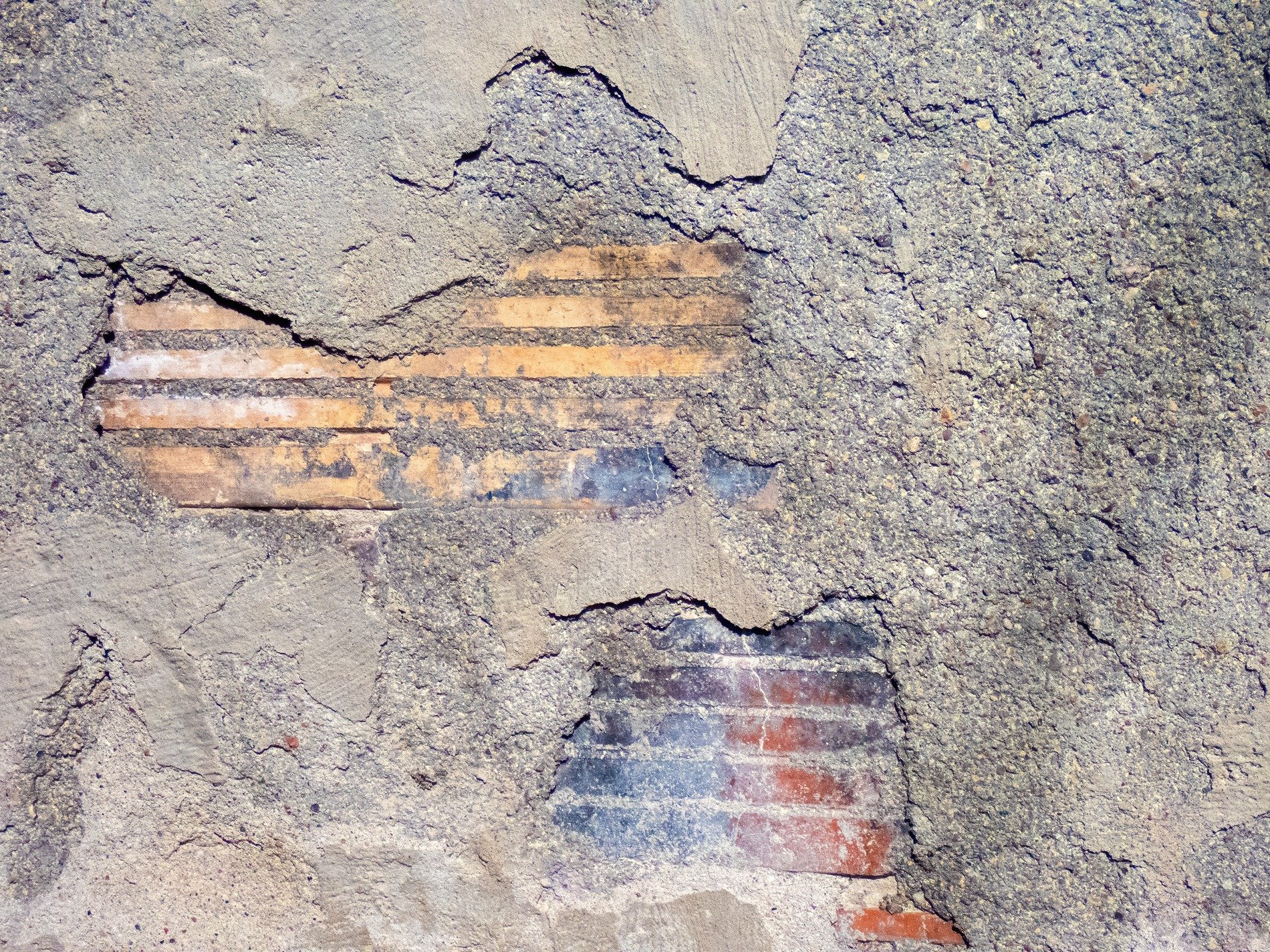 Grey concrete crumbles, hidden brickwork peeks through gaps, ancient walls decay