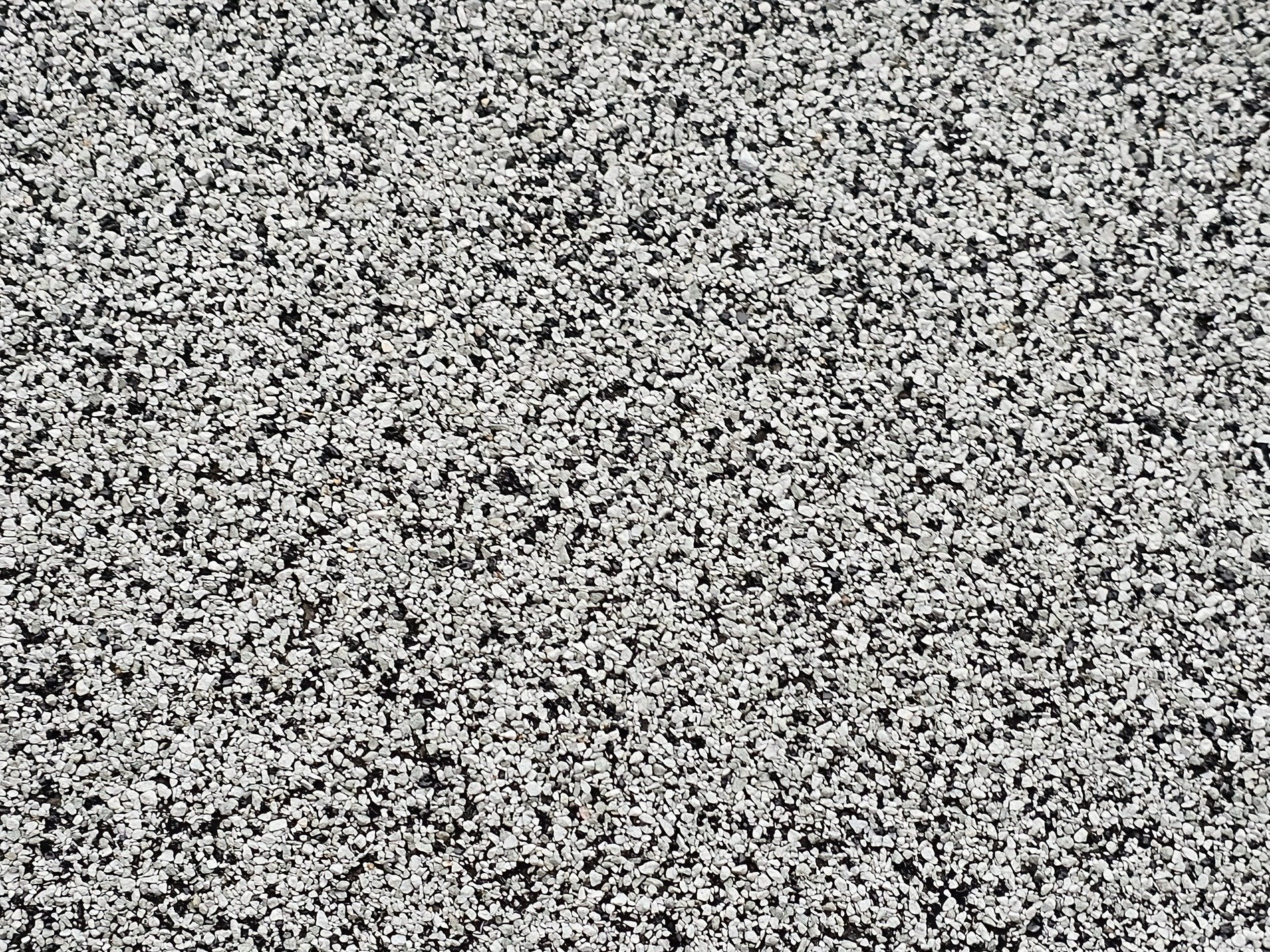 Grey stones meet the light, jagged grit claims the surface, paths show the heavy way