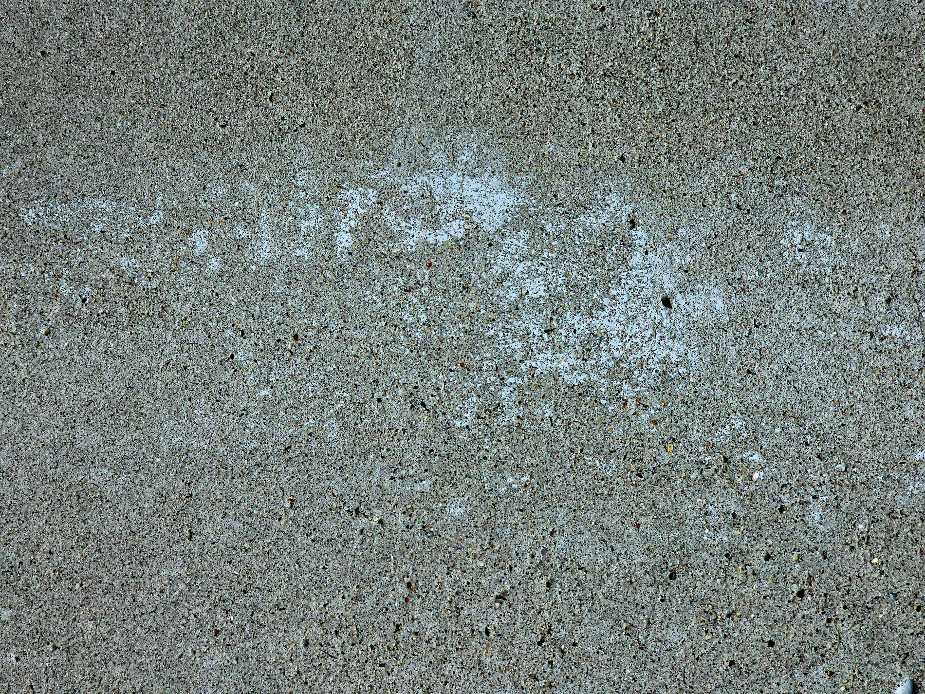 Grey wall weeps in rain, vertical stains mark the time, concrete breathes in salt