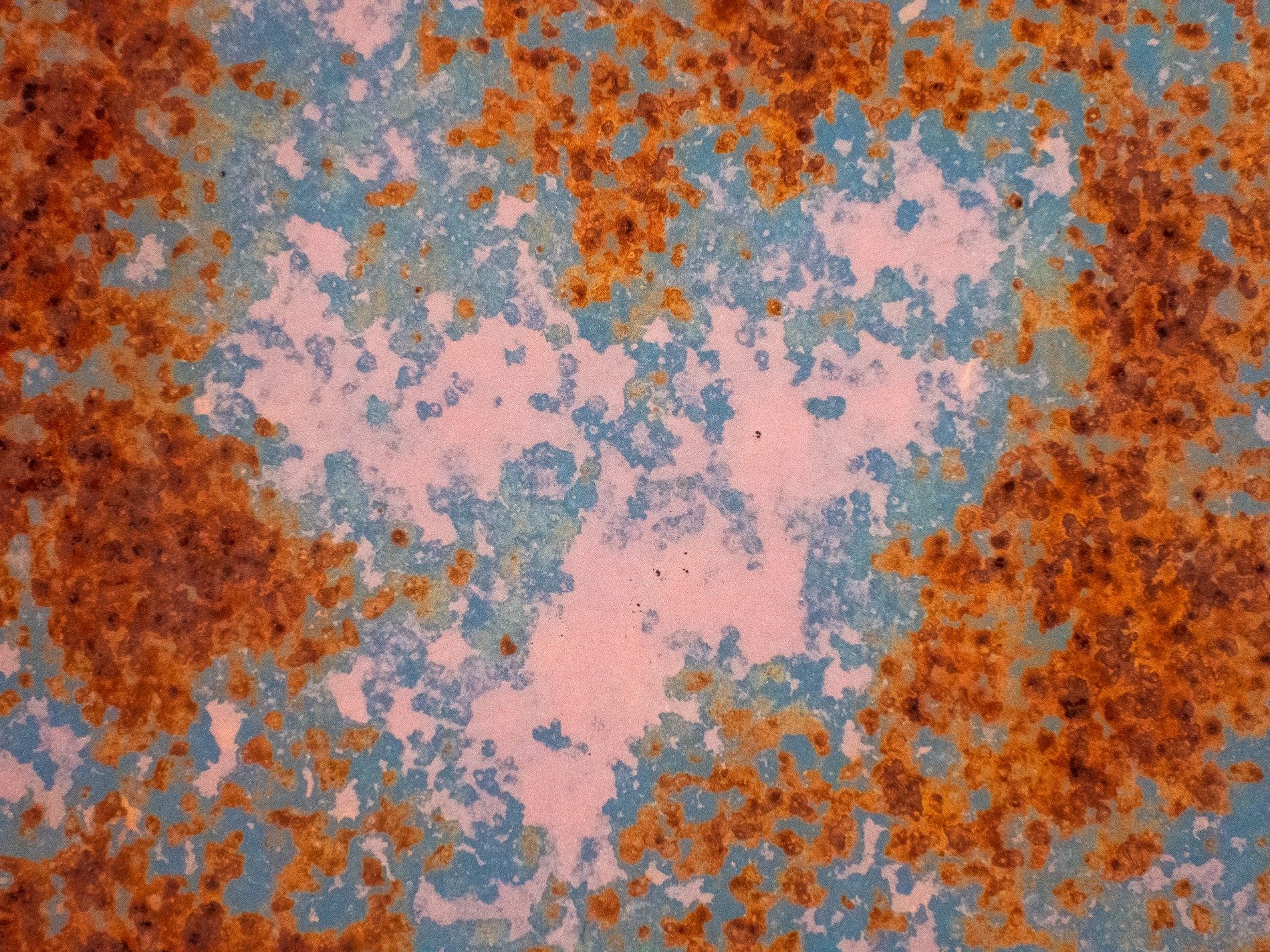 Heart of blue meets light, orange grit claims the metal, years leave a deep trace