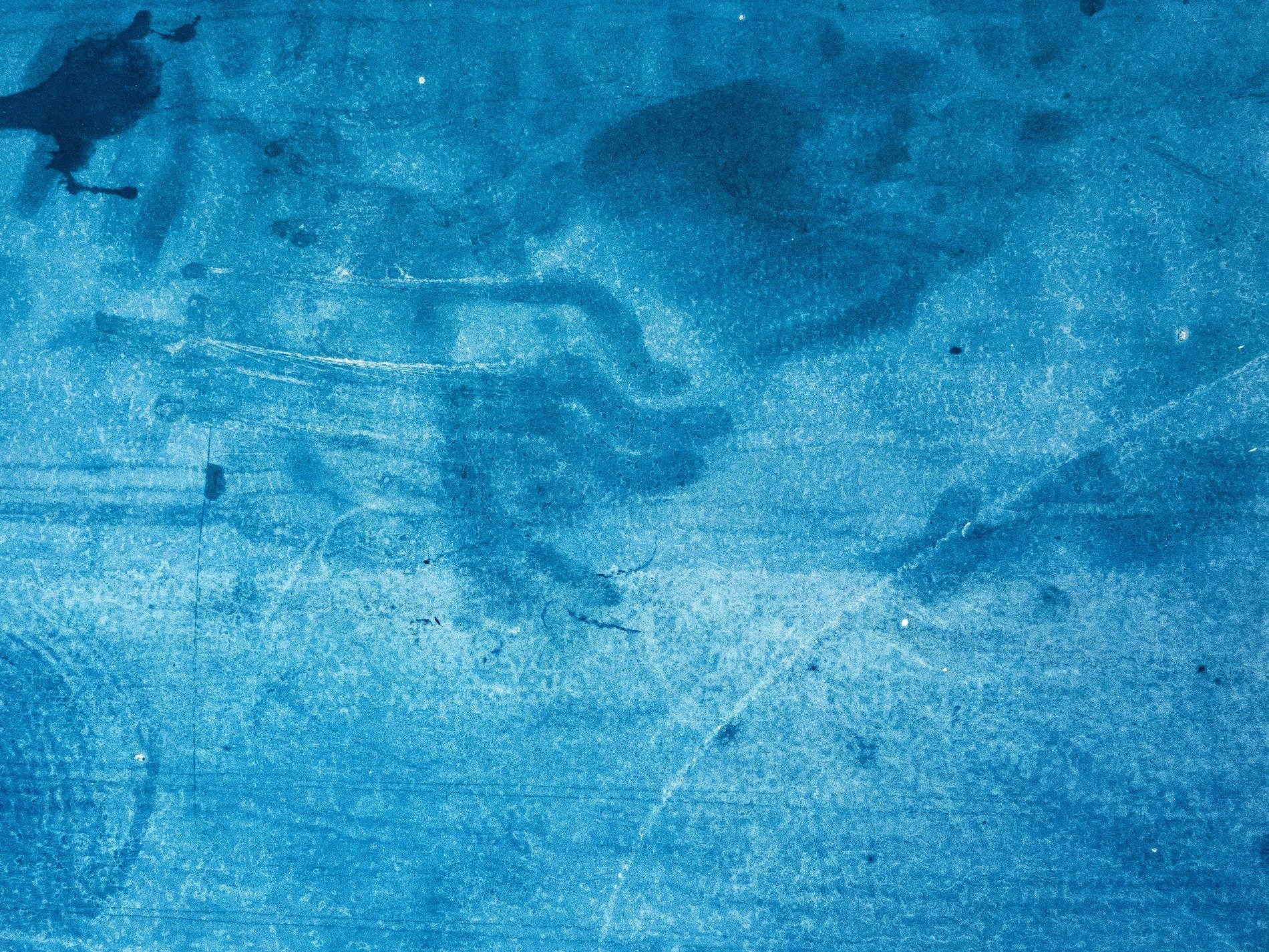 Jagged lines cut deep, dark stone holds the heavy mark, grit stays in the groove