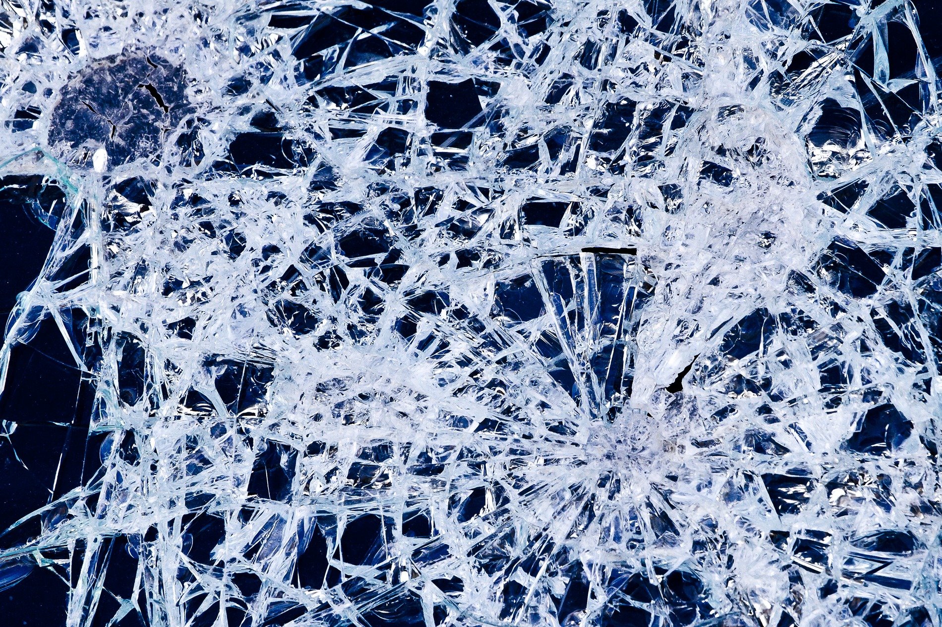 Jagged lines divide, clear shards hold the heavy light, fractured patterns stay