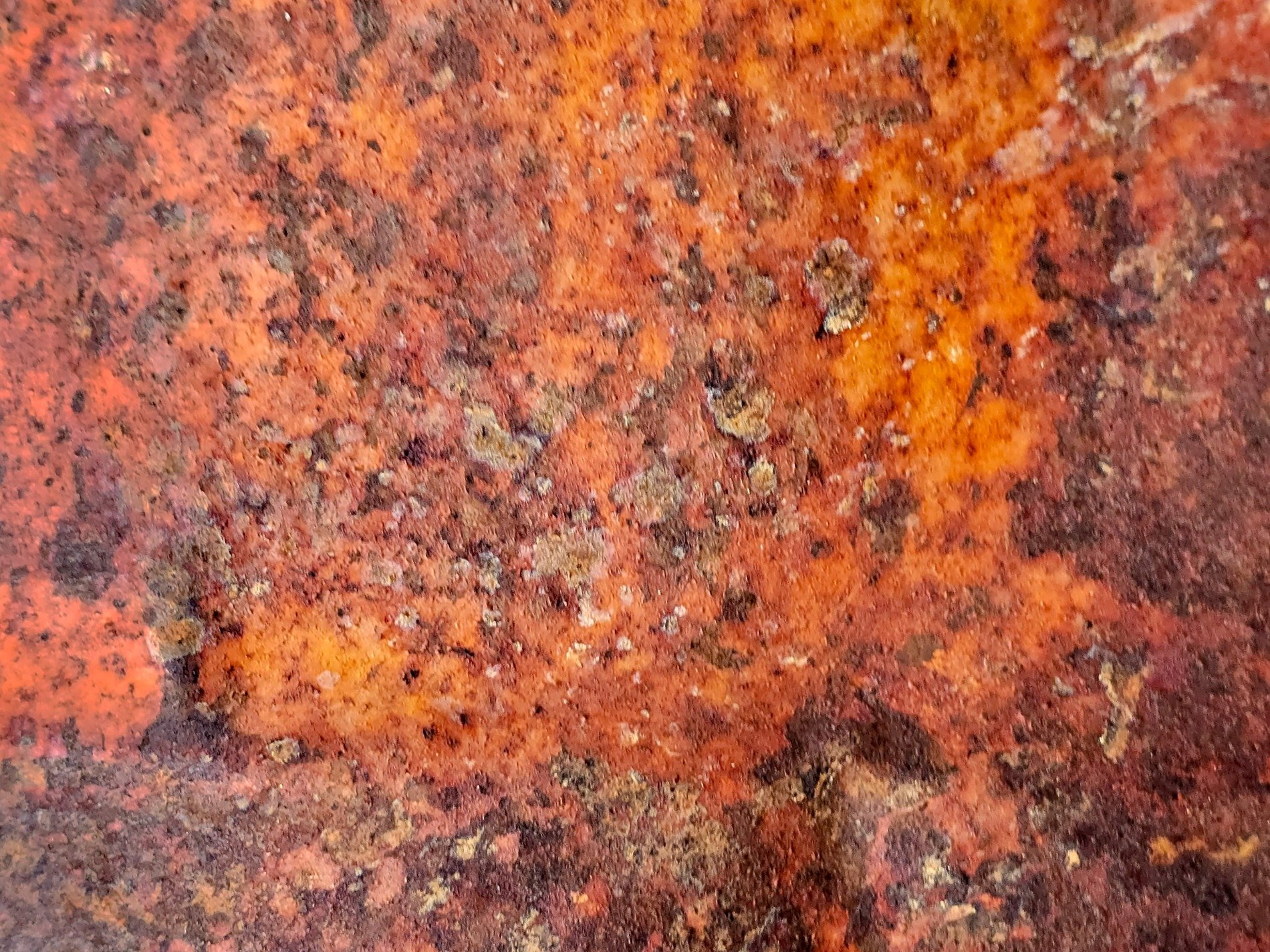 Maroon fields meet the light, vertical marks trace the field, grit holds the pattern