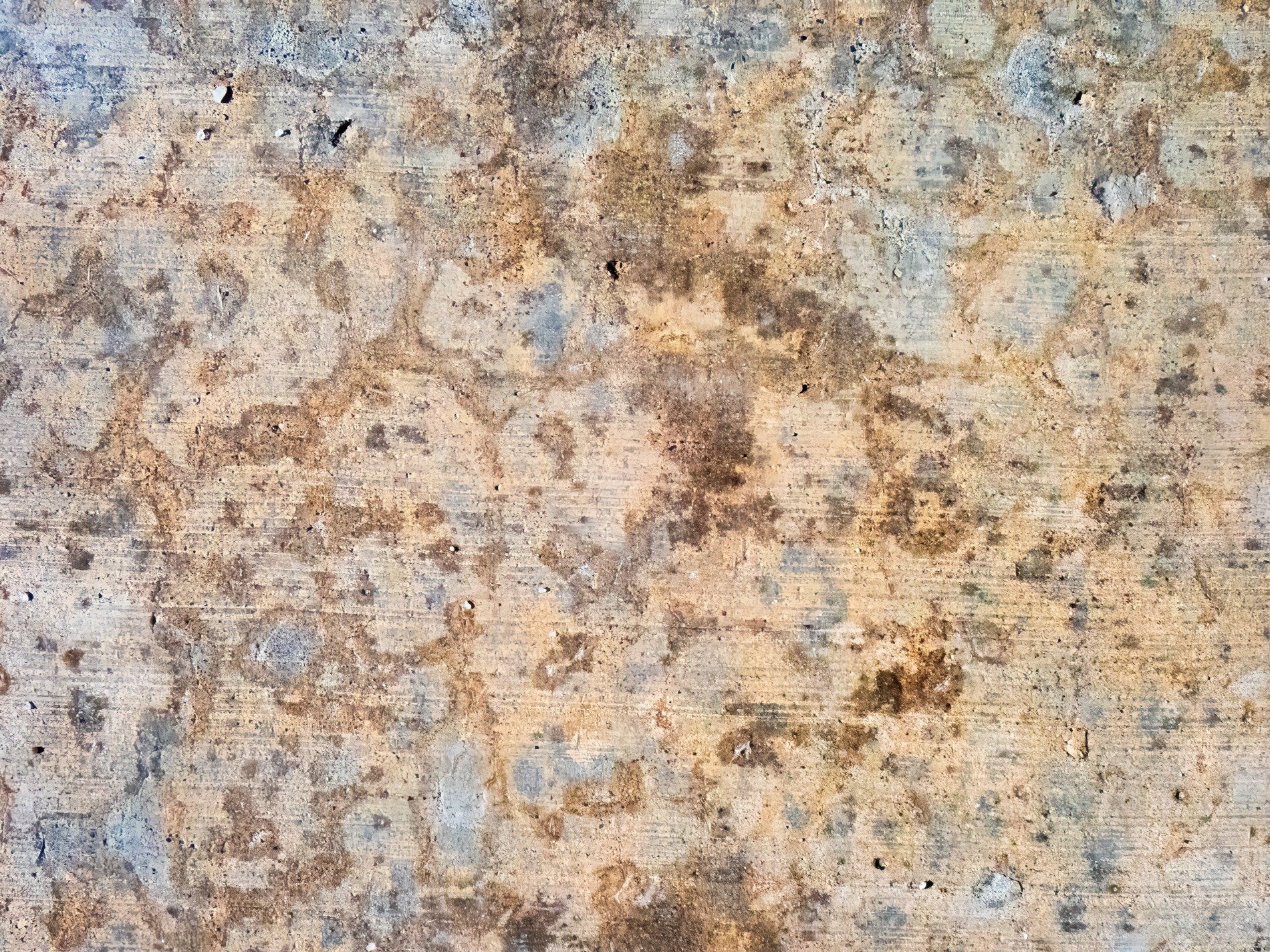 Mottled earth on grey, horizontal lines remain, stone bears time and dust