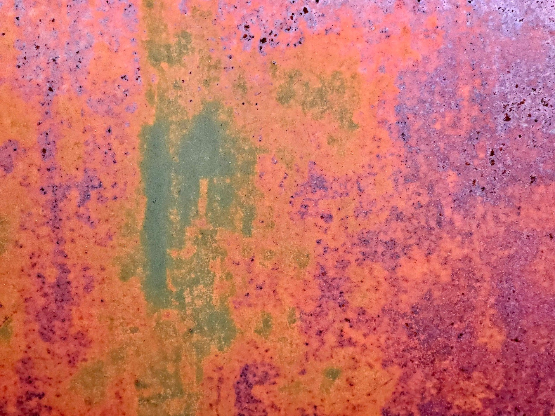 Orange dust takes hold, purple stains the metal skin, green light hides beneath