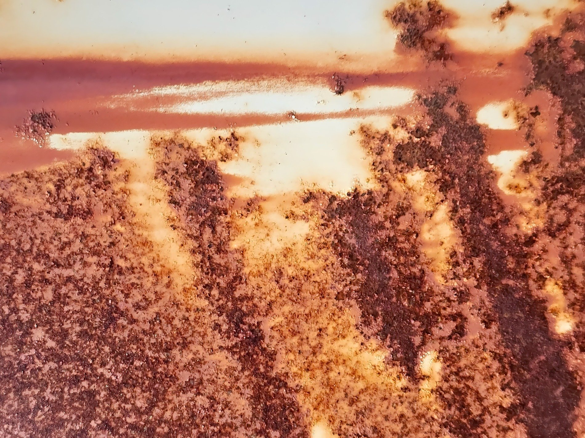 Orange grit flows thick, heavy rust claims the surface, time leaves a deep trace