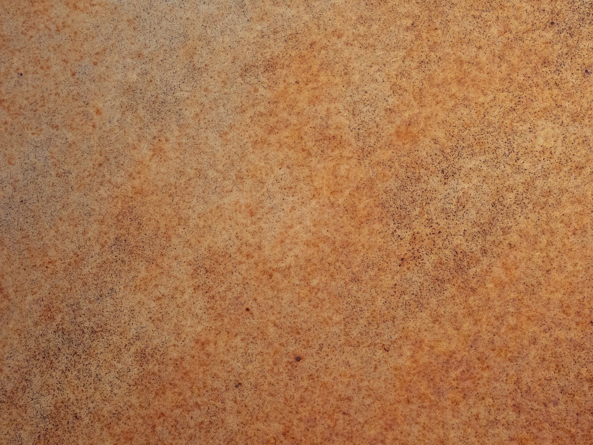 Orange iron blooms, oxidation eats the steel, grains of dust remain