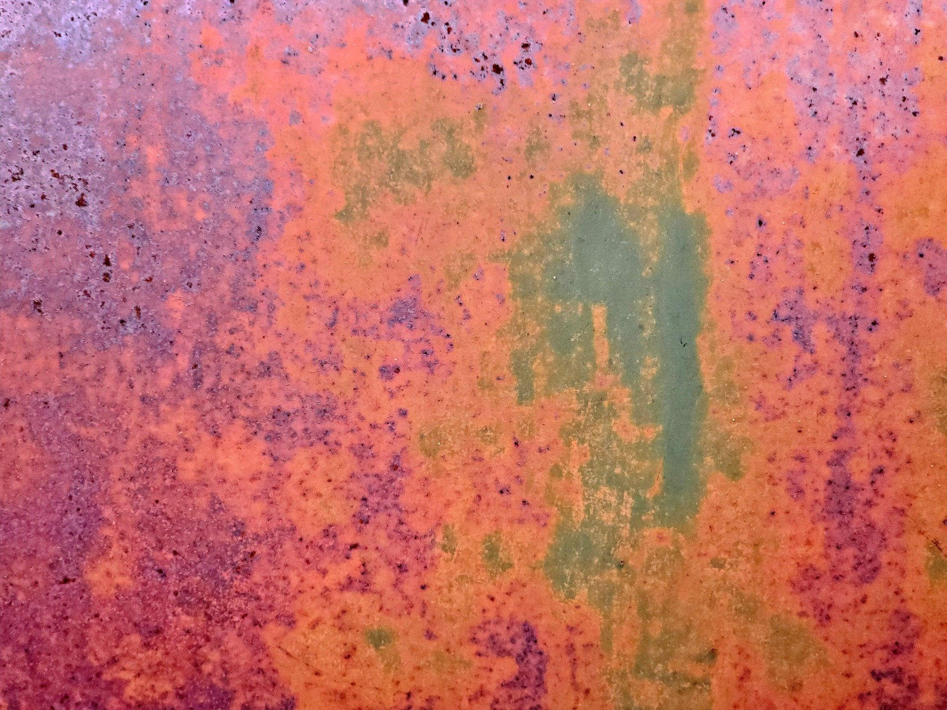 Orange oxide blooms, purple shadows haunt the steel, weathered metal fades